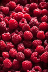 Raspberries group in box on dark background