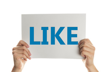 Hand holding a banner with the words like