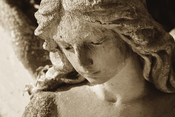 Vintage image of a sad angel on a cemetery