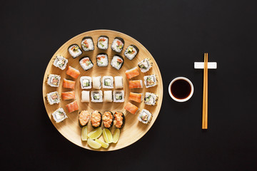 Set of sushi maki and rolls at black background