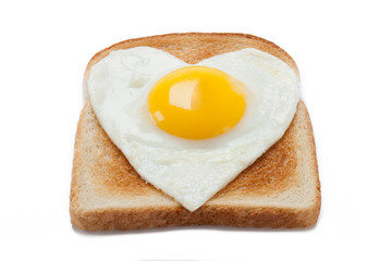 bread toast with a fried egg in a heart shape.