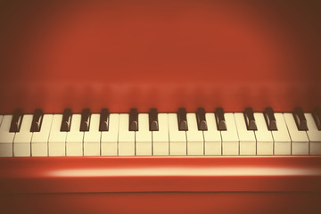 Piano keys of red piano close up