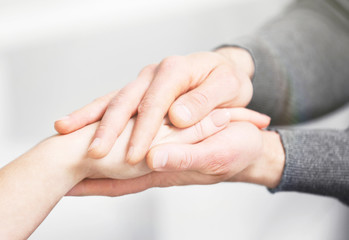 Man and woman holding hands closeup