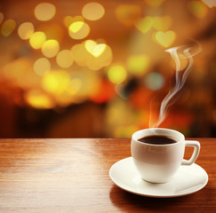 Cup of coffee on table on blured cafe background