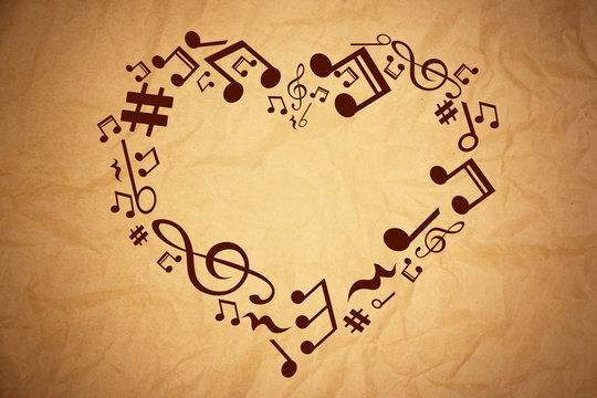 Heart collected from musical notes on brown background