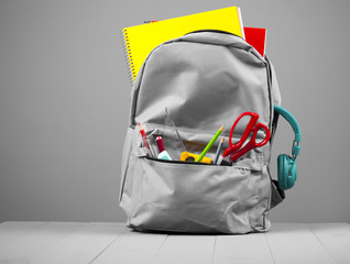 Full school backpack on grey background