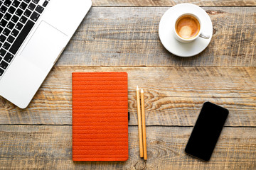 Working place with notebook on wooden table