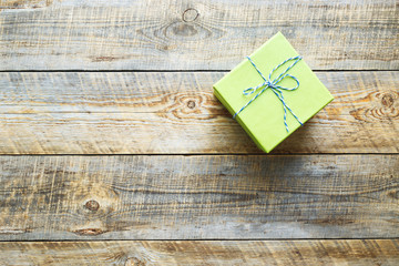 green gift box and on old wooden table