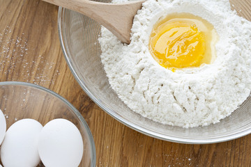 overhead shot of flour with egg yolk.