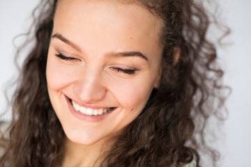 Naklejka premium Happy smiling young woman face with closed eyes.Close-up portrait