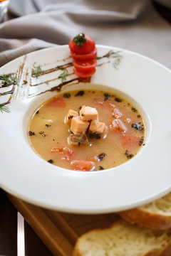 fish soup in the plate on a wooden tray