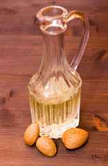 Bottle with almond oil on wooden table
