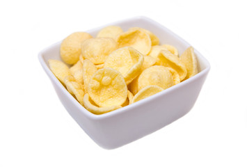 Potato snacks on a square bowl on white background