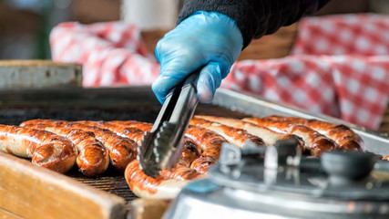 Sausages Cooking On Grill. Street Food Market Vendor - obrazy, fototapety, plakaty