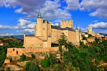 Fototapeta na wymiar Beautiful Segovia Castle, Spain perched on a rocky hill with the old town behind