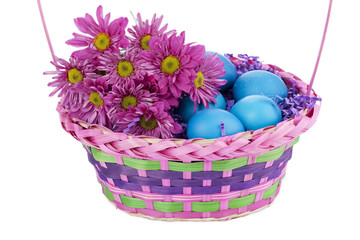 basket with easter eggs and flower