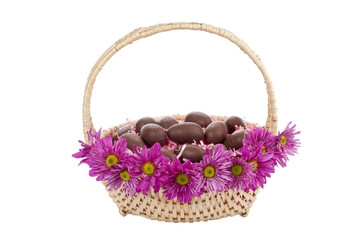 Fototapeta na wymiar basket with flowers and chocolate easter eggs