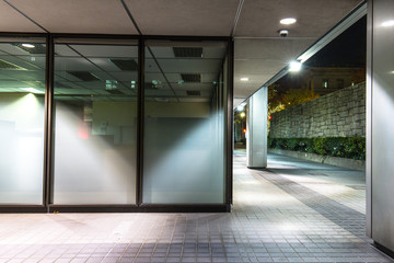 empty footpath front of modern business building at night