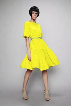 Brunette woman in yellow dress 