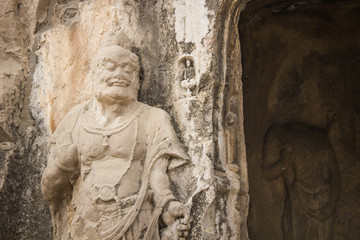 Fototapeta na wymiar Porter's statue rock carving at Longmen Grottoes, Luoyang , Hena
