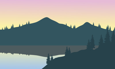 View of gray mountains with reflection in lake
