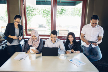 business people busy with their own gadget