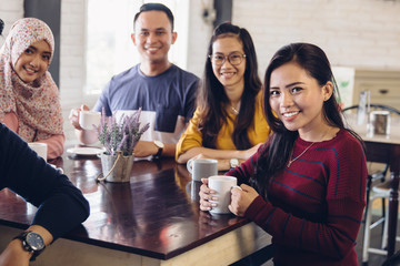 friend having fun together in a cafe