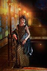 girl in evening dress near street lamp