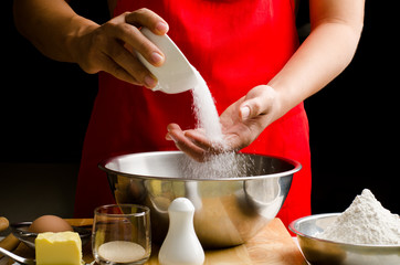 Preparation bread cooking,pouring the sugar in the the bowl
