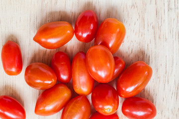 Close-up of fresh, ripe tomatoes on wood background