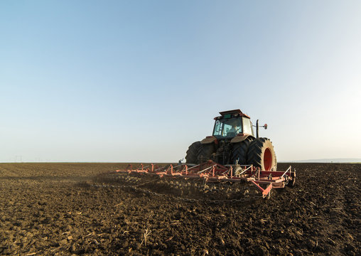 Tractor preparing land