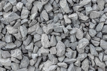 Texture of a gray macadam pile seamless background.