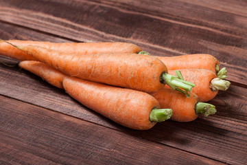 fresh carrots on wooden background