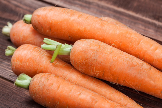 fresh carrots on wooden background