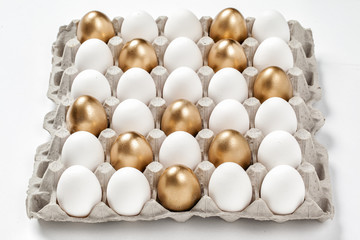 golden egg concept among white eggs in carton pack
