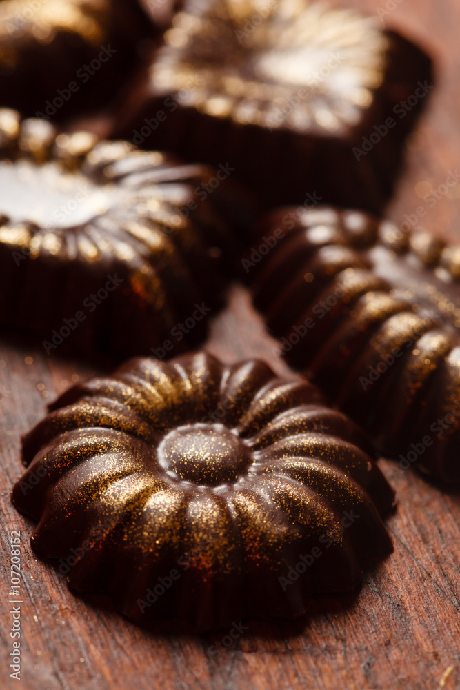 Sticker chocolate sweets with edible golden powdeer