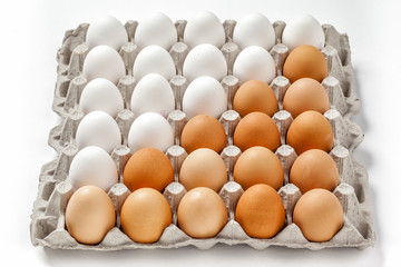 white and brown eggs lying in lattice in order