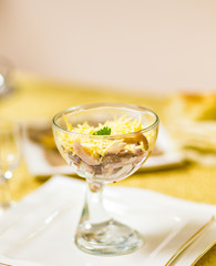 Salad with sticks of surimi, corn, eggs and mayonnaise on white table