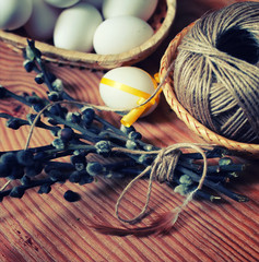 spring willow and egg on a wooden background