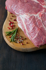 raw pork neck meat on wooden table