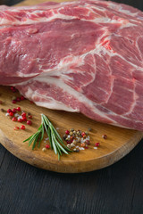 raw pork neck meat on wooden table