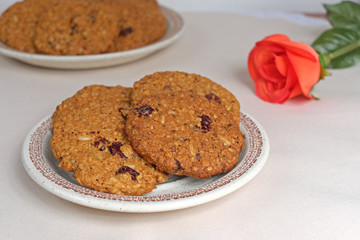 Homemade cookies oatmeal dried cranberries and red rose