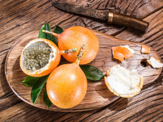 Granadilla fruits on the wooden table.