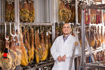 butcher hanging wurst and jamon