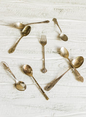 Spoon and fork on white wooden table