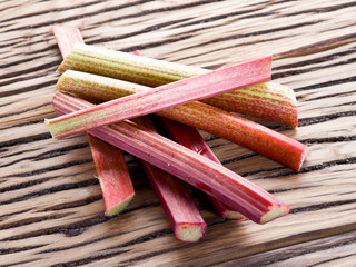 Rhubarb stalks on the wooden table.