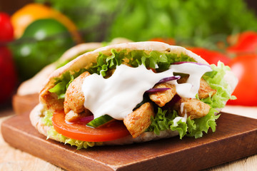 Pita salad with roasted chicken and vegetables, served with a de