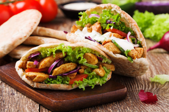 Pita salad with roasted chicken and vegetables, served with a de