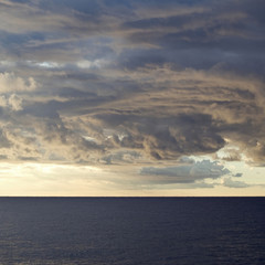 Dark cumulus clouds hovering over the sea