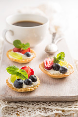 Small berry cakes on white background